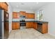Well-equipped kitchen with stainless steel appliances, light wood cabinets, and granite countertops at 2475 E Vermont Dr, Gilbert, AZ 85295