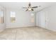 Versatile living space with tile floors, neutral paint, large window, and a ceiling fan at 2475 E Vermont Dr, Gilbert, AZ 85295