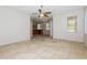 Open-concept living area with tile flooring, neutral paint, arched entryway, and a ceiling fan at 2475 E Vermont Dr, Gilbert, AZ 85295