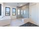 Elegant bathroom featuring a modern tub, glass-enclosed shower, and neutral tile work at 25564 N 119Th St, Scottsdale, AZ 85255
