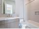 Modern bathroom featuring neutral tile, a soaking tub, and a marble-top vanity at 25564 N 119Th St, Scottsdale, AZ 85255