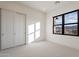 Bright bedroom featuring a large window with mountain views and a spacious closet at 25564 N 119Th St, Scottsdale, AZ 85255