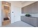 Hallway with wood floors, gray built-in storage, and white walls, creating a clean, modern look at 25564 N 119Th St, Scottsdale, AZ 85255