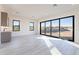 Living room with a kitchenette featuring large windows, light floors, and desert views at 25564 N 119Th St, Scottsdale, AZ 85255