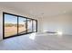 Sunlit living room with large sliding doors and views of the desert landscape at 25564 N 119Th St, Scottsdale, AZ 85255
