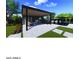 Stylish outdoor kitchen and dining area, complete with a built-in grill and adjacent pool at 25564 N 119Th St, Scottsdale, AZ 85255