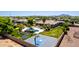Aerial view of estate, large backyard featuring a pool, grotto, outdoor kitchen, and basketball court at 2892 E Fruitvale Ave, Gilbert, AZ 85297