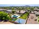 Sprawling backyard featuring a pool, spa, outdoor kitchen, basketball court, and lush landscaping at 2892 E Fruitvale Ave, Gilbert, AZ 85297
