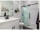 Modern bathroom offers tile shower with glass doors, white cabinetry, and neutral colors at 2892 E Fruitvale Ave, Gilbert, AZ 85297