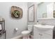 Well-lit powder room features a modern sink and vanity, decorative wall art, and neutral tones at 2892 E Fruitvale Ave, Gilbert, AZ 85297