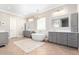 Elegant bathroom featuring a modern freestanding tub, dual vanities, and herringbone floors at 2892 E Fruitvale Ave, Gilbert, AZ 85297