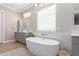Bright bathroom showcasing a standalone tub, gray cabinets, and stylish fixtures at 2892 E Fruitvale Ave, Gilbert, AZ 85297