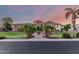 Stunning stone home with a circular turret, lush landscaping, and paver walkway leading to the front door at 2892 E Fruitvale Ave, Gilbert, AZ 85297