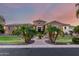 Gorgeous stone home featuring a circular turret, mature palm trees, and a welcoming paver walkway at 2892 E Fruitvale Ave, Gilbert, AZ 85297