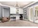 Home office with white cabinets, desk space, an elegant chandelier, and a French door to the patio at 2892 E Fruitvale Ave, Gilbert, AZ 85297