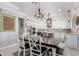 Bright eat-in kitchen features white cabinetry, stainless steel appliances, and a dark wood dining table at 2892 E Fruitvale Ave, Gilbert, AZ 85297