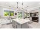 Spacious kitchen island with granite countertops, stainless steel sink, and views into the living room at 2892 E Fruitvale Ave, Gilbert, AZ 85297