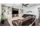 Cozy living room with custom built-in shelves, a stone entertainment center, and a comfortable leather sofa at 2892 E Fruitvale Ave, Gilbert, AZ 85297