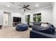 Spacious living room featuring a large sectional sofa, ceiling fan, and neutral decor at 2892 E Fruitvale Ave, Gilbert, AZ 85297
