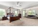 Spacious primary bedroom with a four-poster bed, neutral decor, and ample natural light at 2892 E Fruitvale Ave, Gilbert, AZ 85297