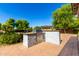 Outdoor kitchen with a built-in grill, stone counter, and lush landscaping in a private backyard at 2892 E Fruitvale Ave, Gilbert, AZ 85297