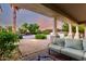 Backyard patio with outdoor seating overlooking a pool and lush landscaping at 2892 E Fruitvale Ave, Gilbert, AZ 85297