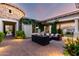 Private patio featuring stylish outdoor furniture, brick pavers, and beautiful landscaping for a serene retreat at 2892 E Fruitvale Ave, Gilbert, AZ 85297