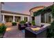 Inviting backyard patio with ample seating on brick pavers, complemented by mature landscaping and elegant pillars at 2892 E Fruitvale Ave, Gilbert, AZ 85297