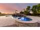 Backyard pool with a spa, rock waterfall feature, and a basketball hoop at 2892 E Fruitvale Ave, Gilbert, AZ 85297