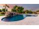 Resort-style pool with a rock waterfall feature and mature landscaping at 2892 E Fruitvale Ave, Gilbert, AZ 85297