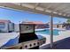 Inviting backyard with a stainless steel BBQ, pool, and covered seating area at 2940 E Norwood St, Mesa, AZ 85213