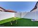 Backyard featuring an artificial lawn and classic yard games, perfect for Gathering entertainment and relaxation at 2940 E Norwood St, Mesa, AZ 85213