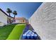 Backyard featuring artificial grass, palm trees, a basketball court, and beer pong at 2940 E Norwood St, Mesa, AZ 85213