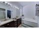 Elegant bathroom with dual vanities, soaking tub, and ample storage, creating a spa-like retreat at 2940 E Norwood St, Mesa, AZ 85213