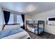 Inviting bedroom featuring a full bed, bunkbeds, and ample natural light at 2940 E Norwood St, Mesa, AZ 85213