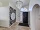 Bright foyer features ceramic tile flooring, a stylish light fixture and designer touches at 2940 E Norwood St, Mesa, AZ 85213