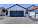 Single-story home features a two-car garage, low-maintenance desert landscaping, and a concrete driveway at 2940 E Norwood St, Mesa, AZ 85213