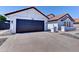 This single-story home includes a two car garage, desert landscaping and a concrete driveway at 2940 E Norwood St, Mesa, AZ 85213