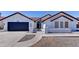 Single Gathering home with a dark garage door and decorative concrete pillars at 2940 E Norwood St, Mesa, AZ 85213
