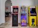 A fun game room featuring an NBA Jam, Wheel of Fortune, and Pac-Personal arcade game set against a dining table backdrop at 2940 E Norwood St, Mesa, AZ 85213