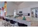 The kitchen features a breakfast bar, white cabinets, stainless steel appliances, and views of the mural and kitchen at 2940 E Norwood St, Mesa, AZ 85213