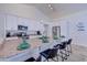 An eat-in kitchen with stainless steel appliances, a breakfast bar, and bright white cabinets at 2940 E Norwood St, Mesa, AZ 85213
