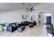Open concept living room area with archways, decorative lighting, neutral tile flooring and ceiling fan at 2940 E Norwood St, Mesa, AZ 85213