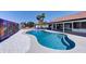 Backyard pool with a basketball court, palm trees, rock landscaping, and covered patio; a perfect outdoor living space at 2940 E Norwood St, Mesa, AZ 85213