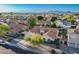 Aerial view of a single-Gathering home with red tile roof in a community near the mountains and a lake at 3058 E Nance St, Mesa, AZ 85213