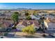 Aerial view of a home in a suburban neighborhood with a neatly kept yard, mountains in the distance and tile roof at 3058 E Nance St, Mesa, AZ 85213