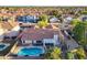 Spacious home features a backyard pool, covered patio, and tiled roof with mature trees in a friendly neighborhood at 3058 E Nance St, Mesa, AZ 85213