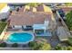 Backyard aerial view featuring a swimming pool with an enclosed fence, patio, yard and detached shed at 3058 E Nance St, Mesa, AZ 85213