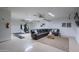 Finished basement with neutral walls, ceiling fans, a large sofa and a gym area at 3058 E Nance St, Mesa, AZ 85213