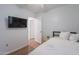 Bedroom features include a mounted television, hardwood floors, and a closet at 3058 E Nance St, Mesa, AZ 85213